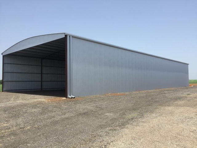 50'x120'x18' Metal Building enclosed on 3 sides and built on dirt floor.